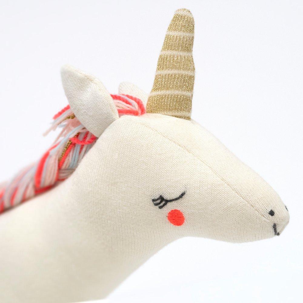 Bella, the unicorn toy, is crafted from knitted organic cotton, has a shiny gold horn and a gorgeous yarn mane and tail. 