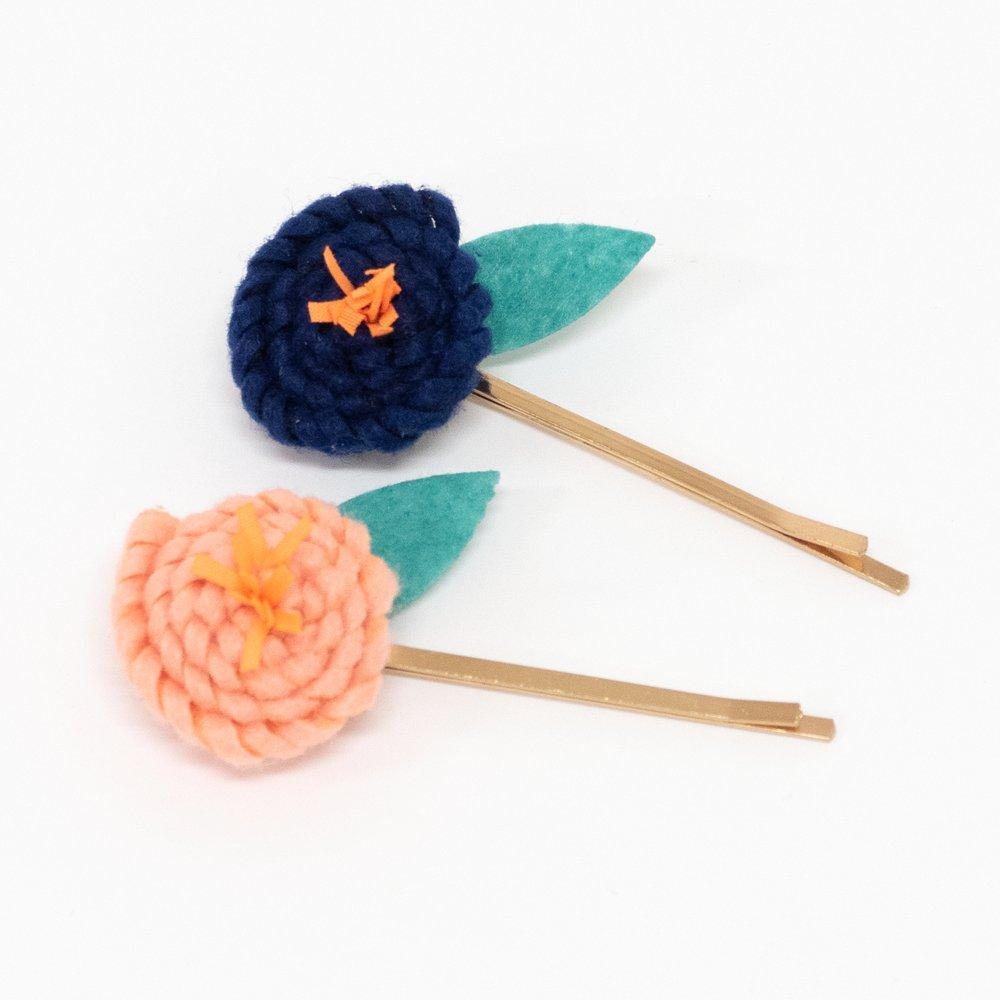 These floral hair slides are beautifully crafted from coloured felt with embroidered details.