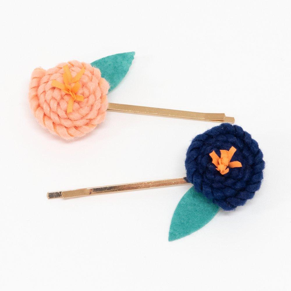 These floral hair slides are beautifully crafted from coloured felt with embroidered details.