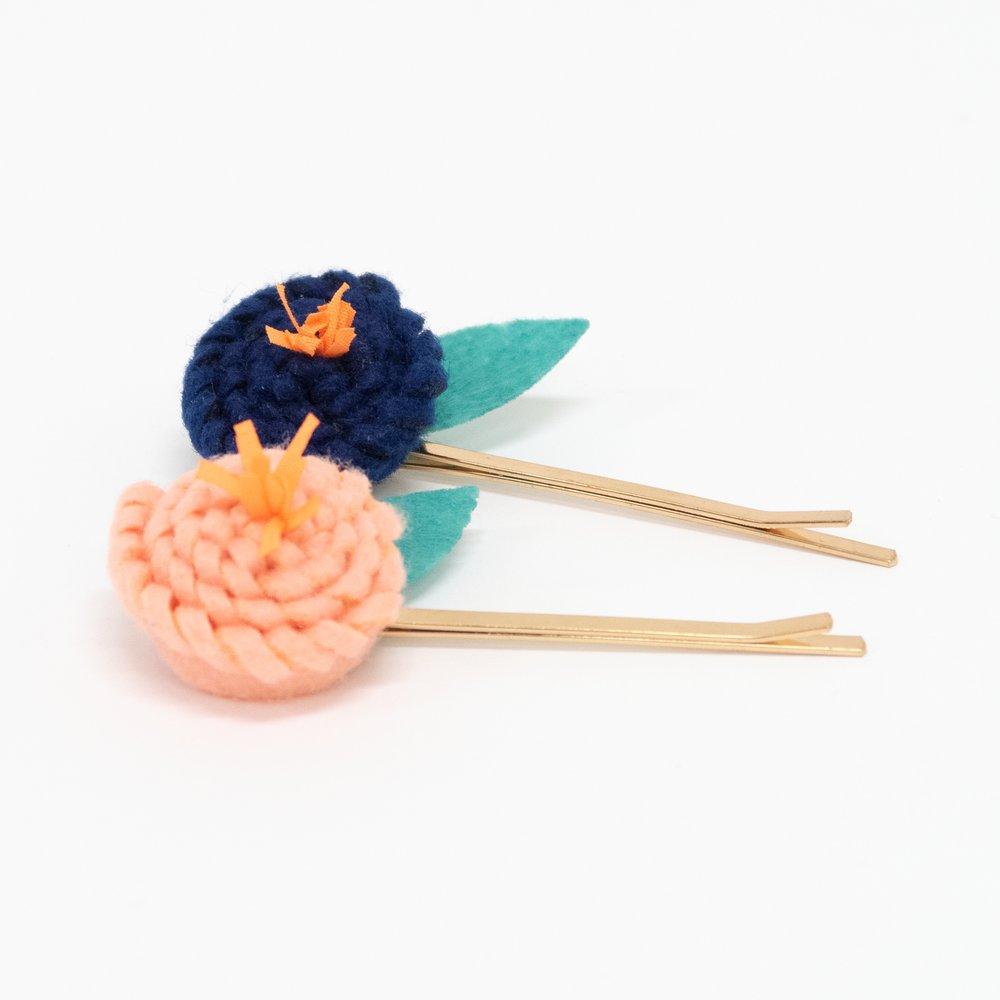 These floral hair slides are beautifully crafted from coloured felt with embroidered details.