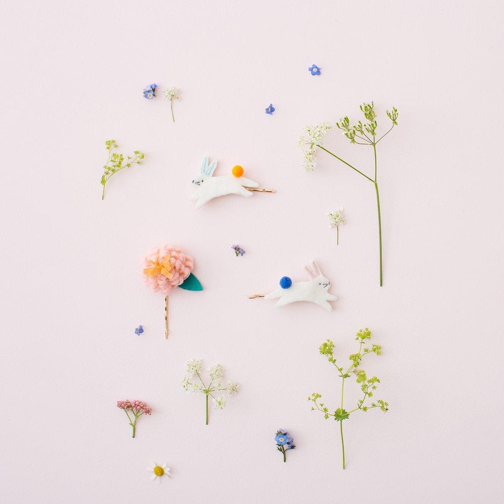 These floral hair slides are beautifully crafted from coloured felt with embroidered details.