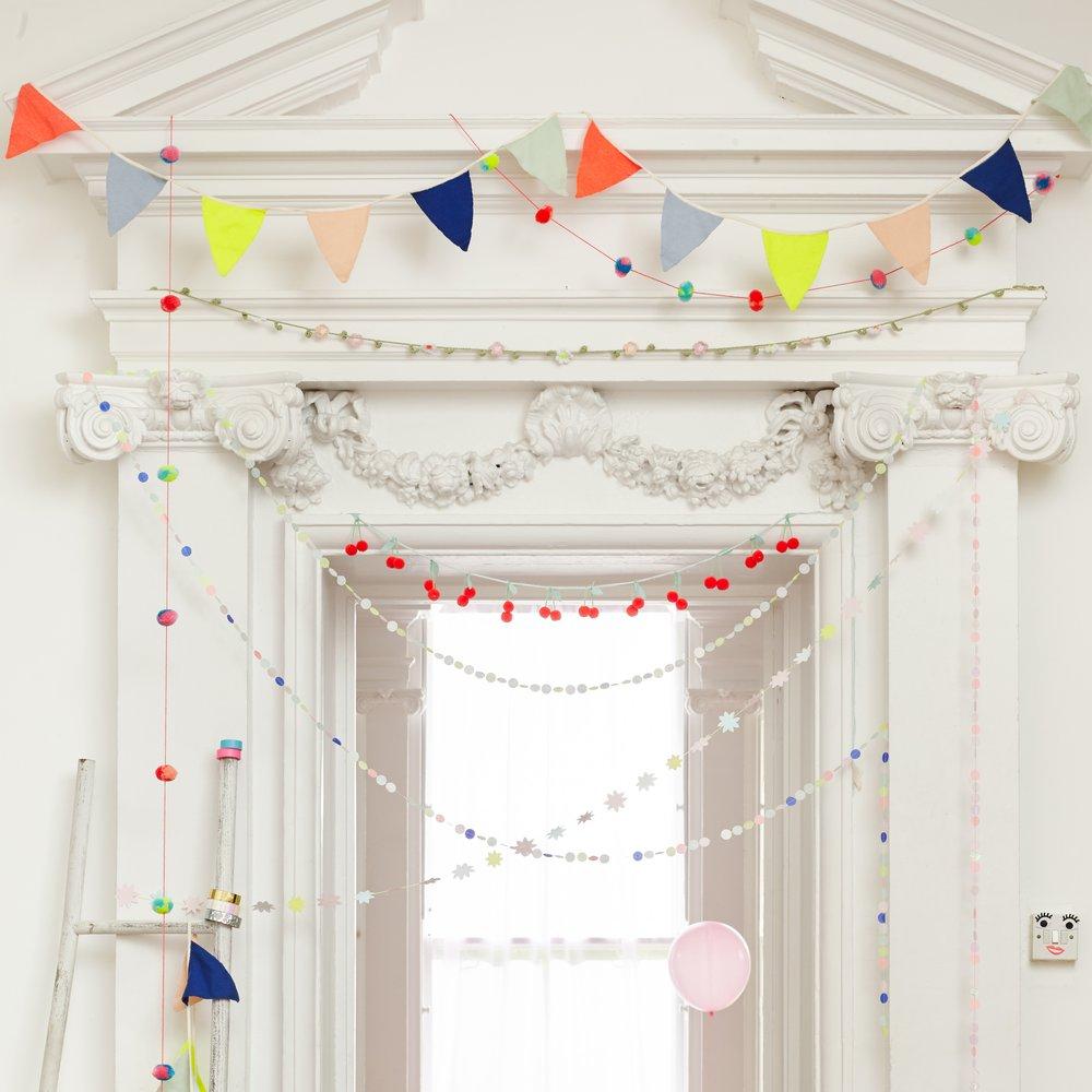 This rainbow room decoration is crafted from confetti pennants in 8 colours.