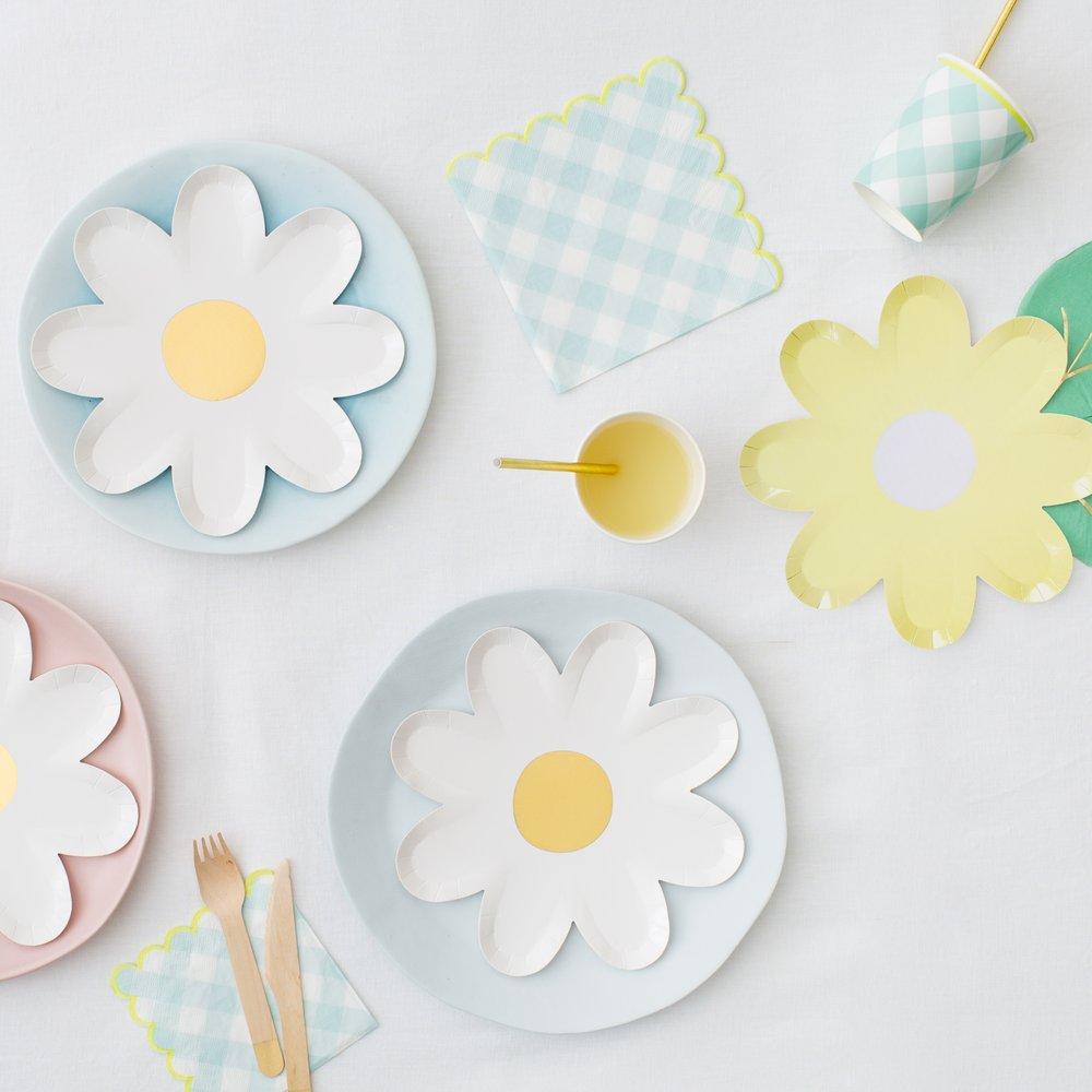 White daisy-shaped paper plates with a gold foil centre