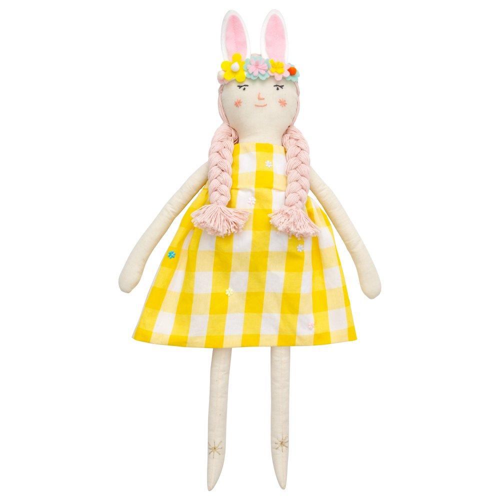 Alice is crafted from fabric, and is wearing a yellow gingham dress and a bunny ear headband. 