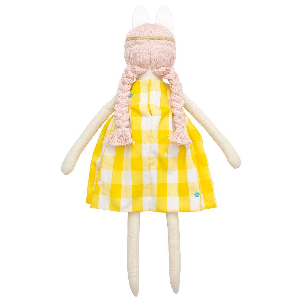 Alice is crafted from fabric, and is wearing a yellow gingham dress and a bunny ear headband. 