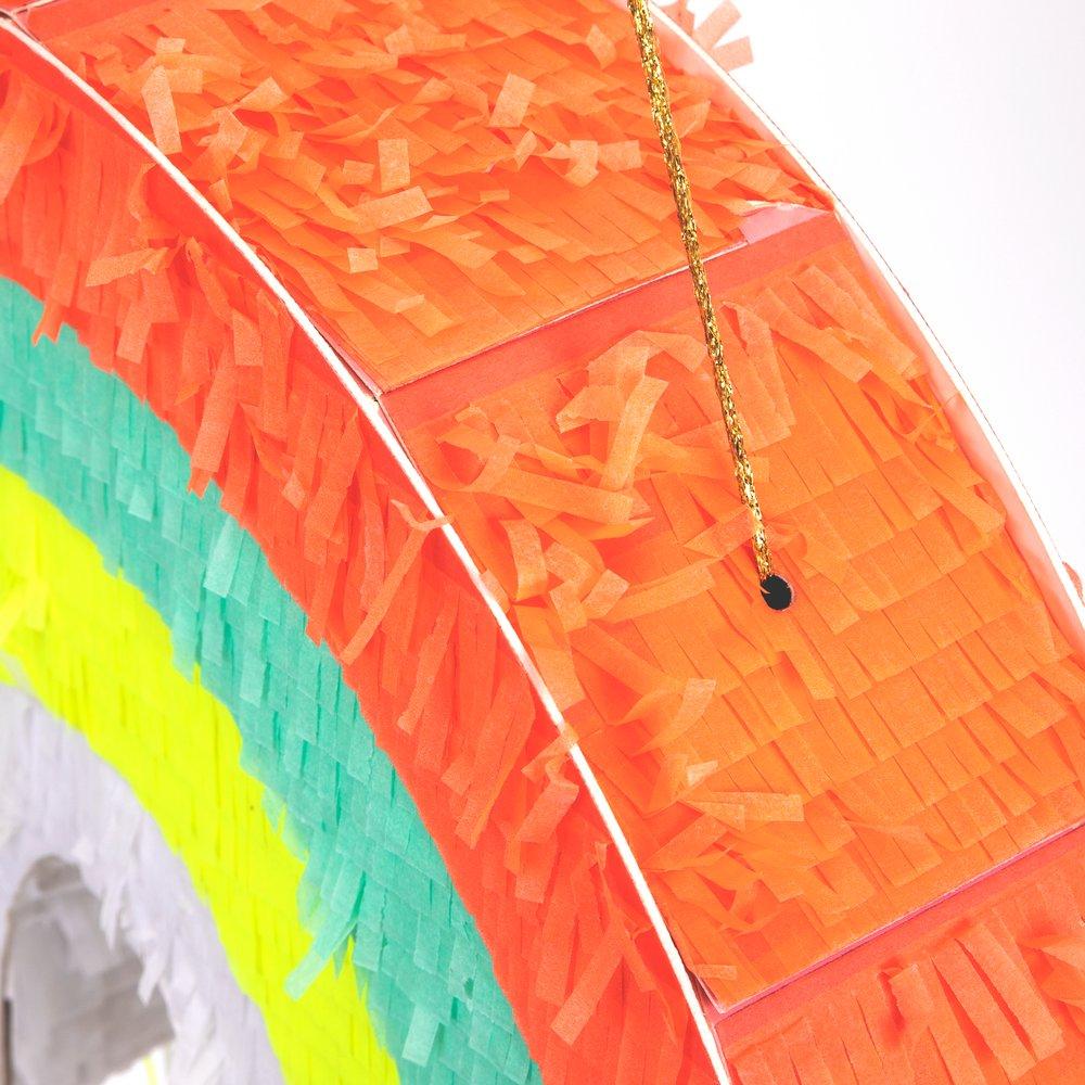 This rainbow pinata is beautifully decorated with colourful stripes and hanging ribbons. 