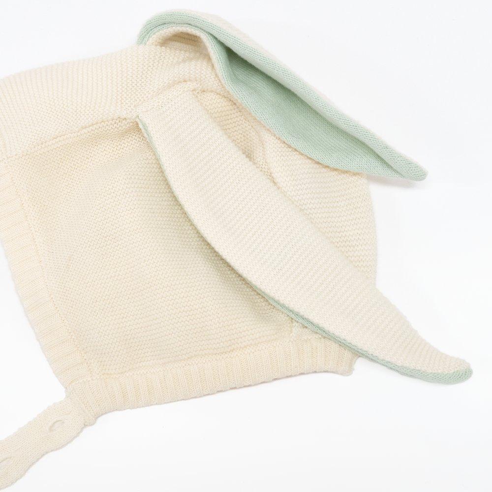 This delightful bunny baby bonnet is crafted from knitted organic cotton, with mint detail on the ears, and fastens with ivory coloured buttons. 