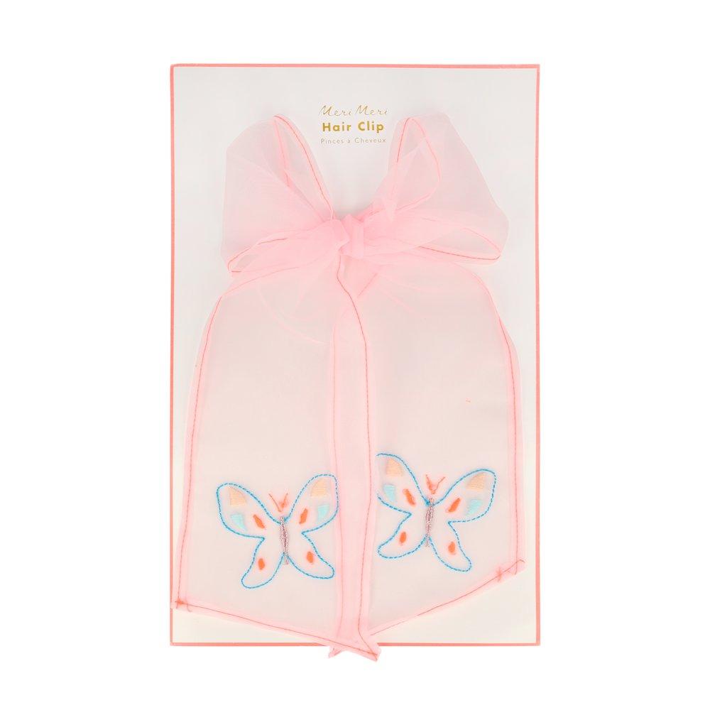 This pretty clip features a  pink net fabric bow which has beautiful butterflies embroidered on it. 