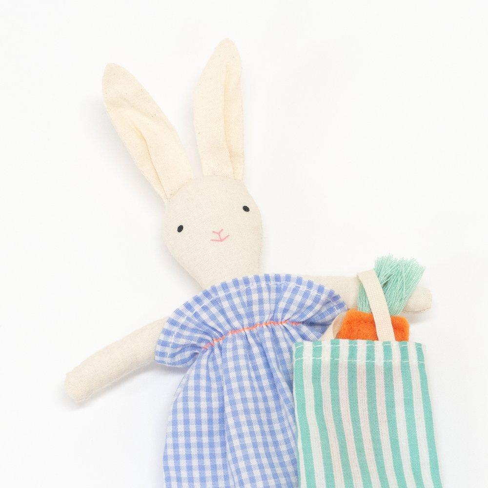 The bunny case opens to reveal an adorable mini bunny doll, with a striped tote bag and felt carrots. 