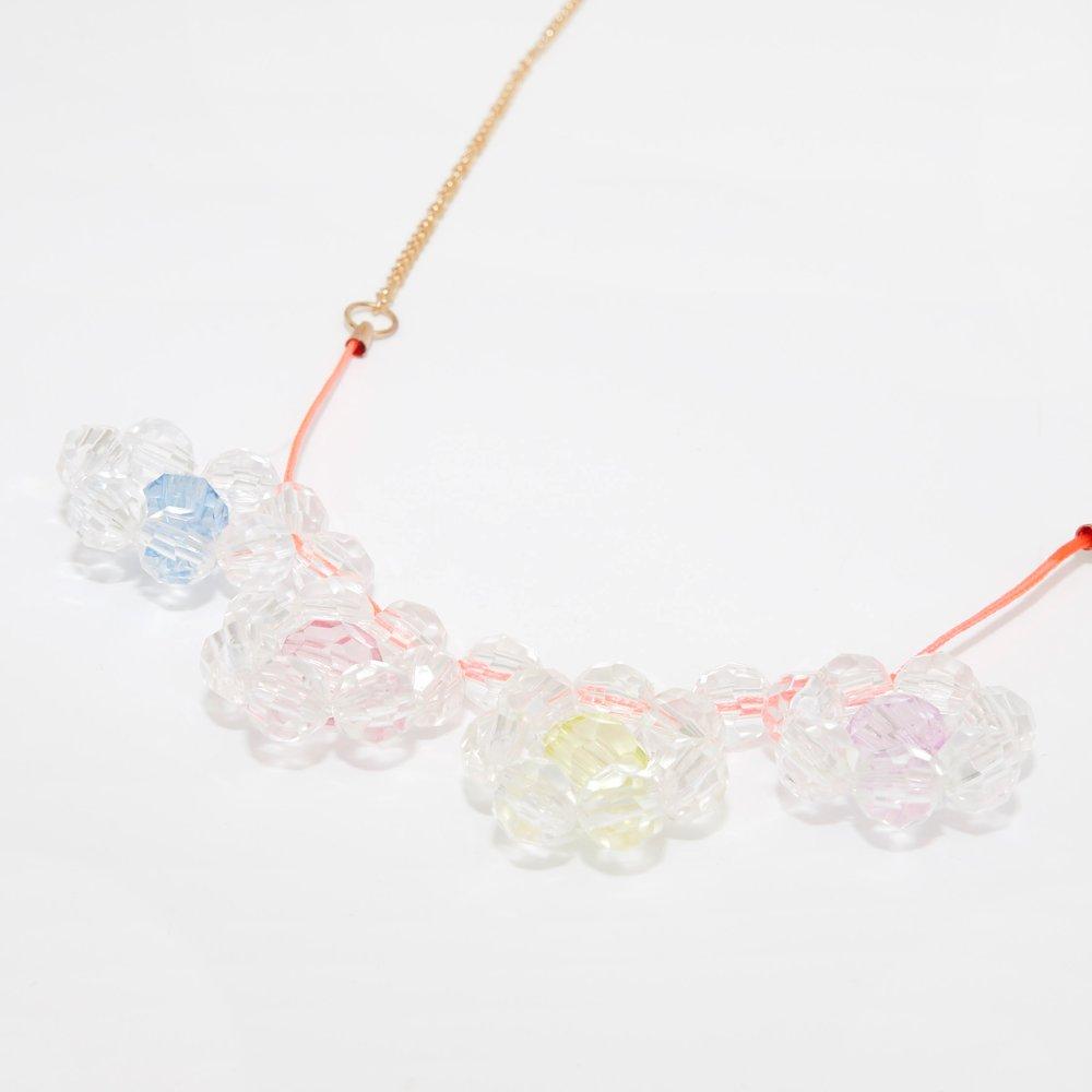 This pretty necklace is crafted with 4 bead flower pennants, and a neon cord with a gold tone chain fastener.