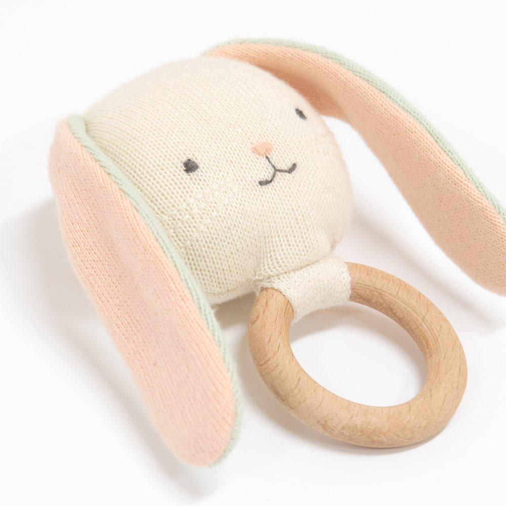 This beautiful bunny rattle is crafted from knitted organic cotton, with sweet stitched features and a wooden grip ring. 