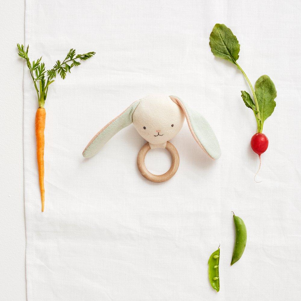 This beautiful bunny rattle is crafted from knitted organic cotton, with sweet stitched features and a wooden grip ring. 