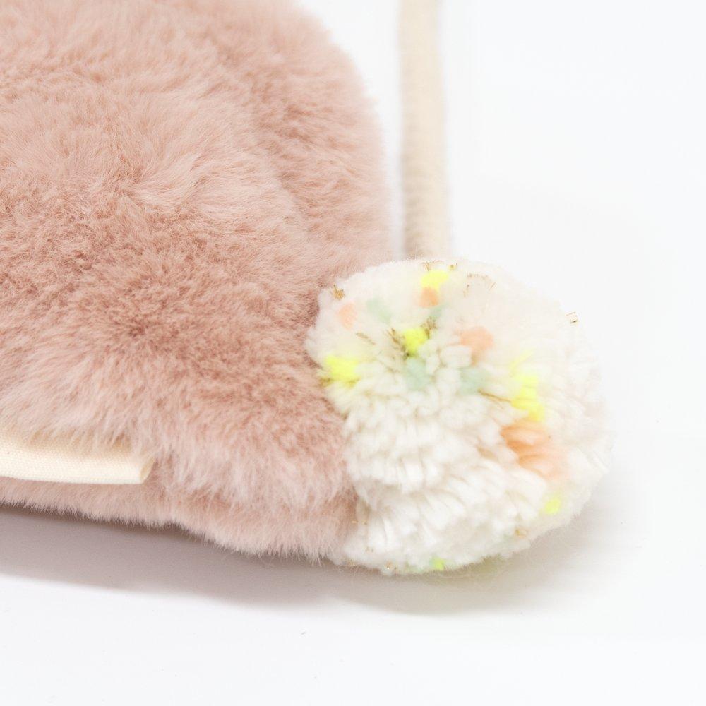 This soft bunny bag, crafted from lined dusky pink plush, has a cross body cord strap, zip closure and pompom tail detail.