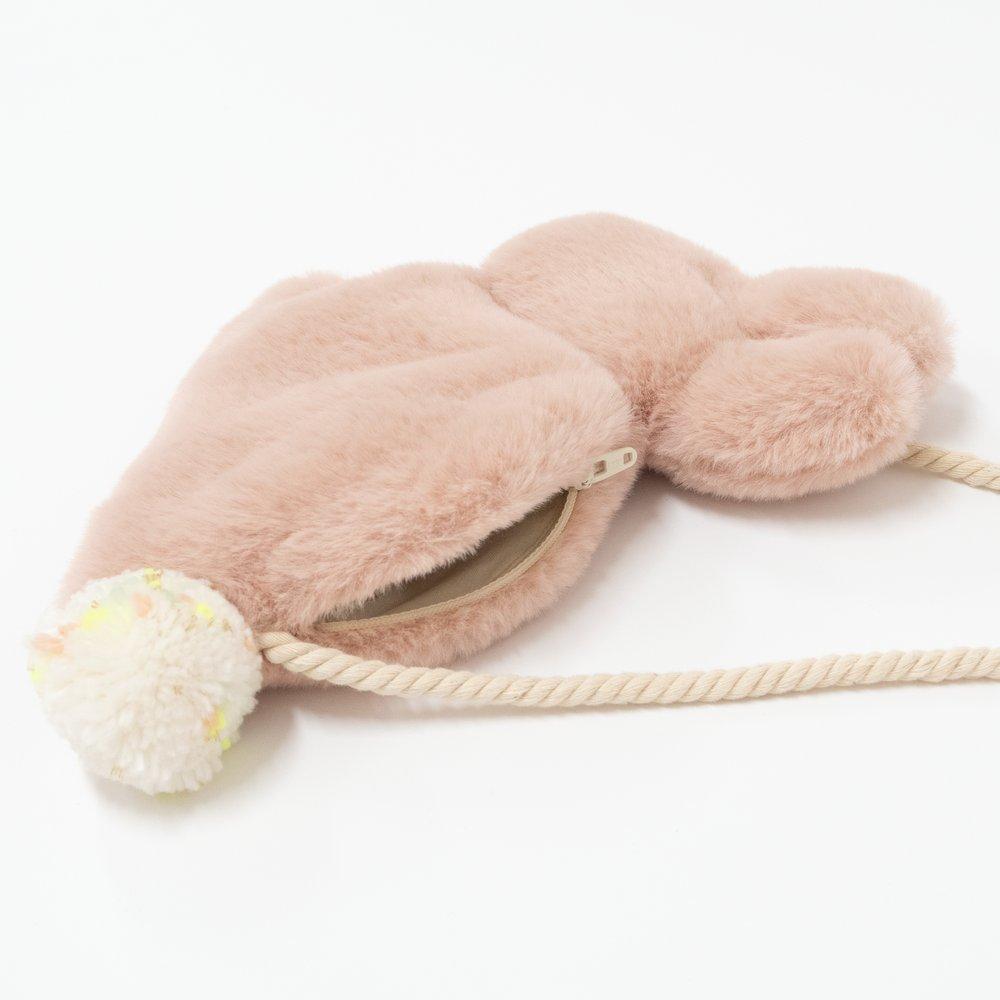 This soft bunny bag, crafted from lined dusky pink plush, has a cross body cord strap, zip closure and pompom tail detail.