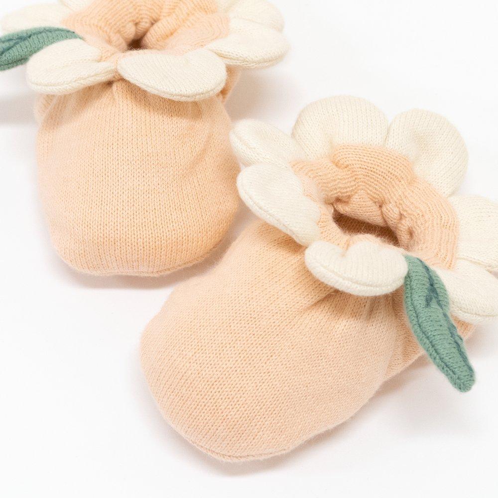 These peach daisy baby booties are crafted from knitted organic cotton, with a peach inner, and cream petal and green leaf detail. 