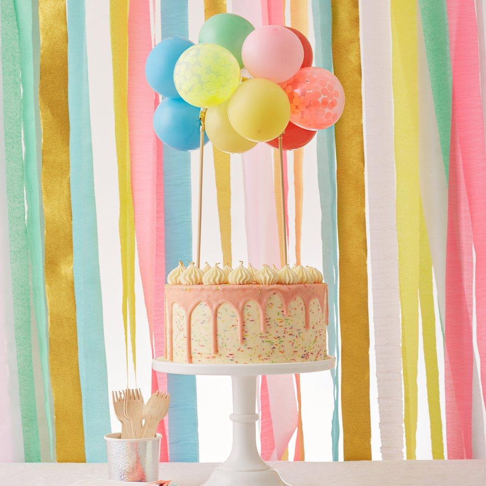 This cake topper kit includes bright balloons, confetti balloons, 2 wooden skewers, a balloon strip and an instruction sheet.