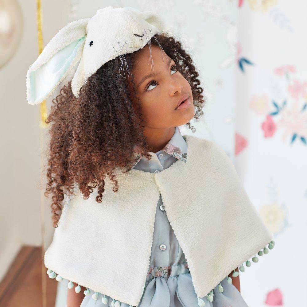 This bunny costumes features a cape and head dress crafted from soft fleece, with embroidered details and a mint lining. 