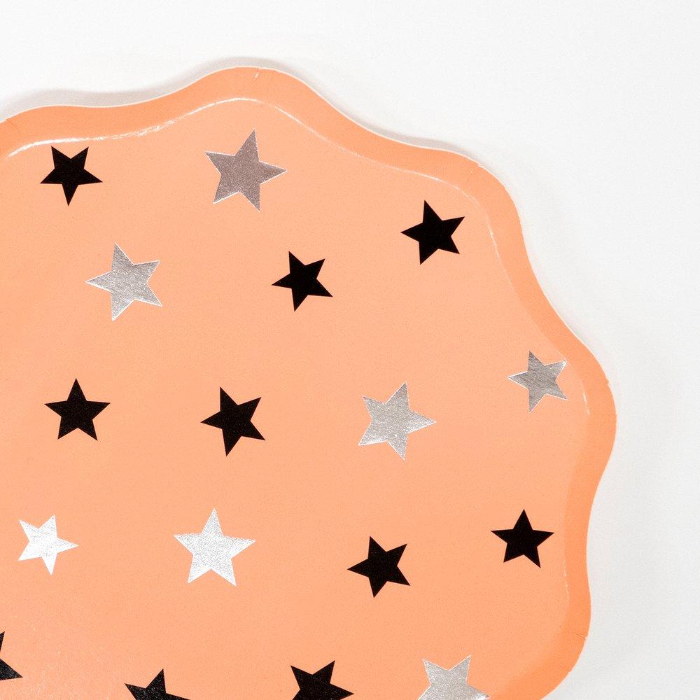 These pastel peach Halloween plates have star decorations and a scalloped edge border. 